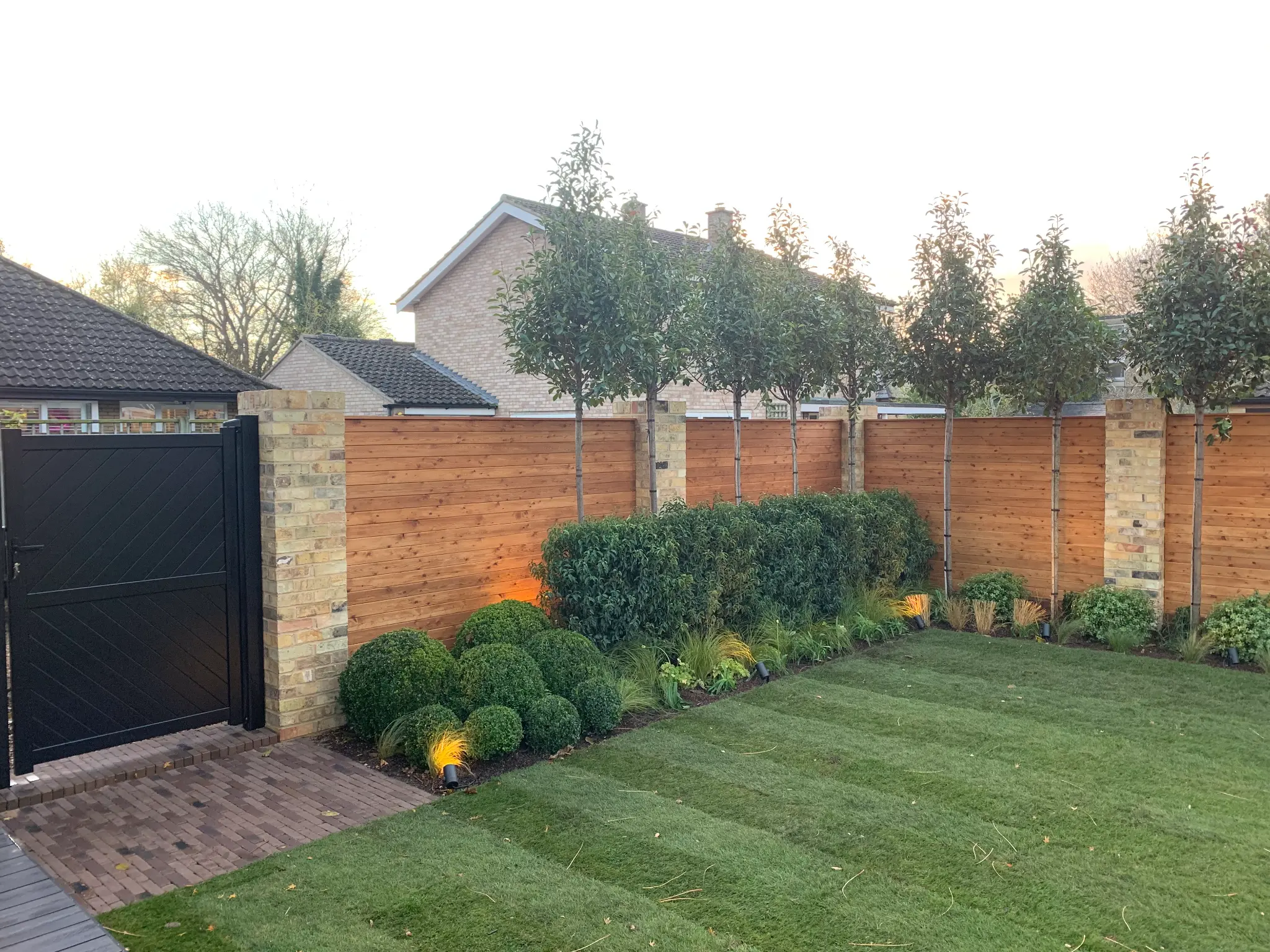 Completed Rowan Gardens boundary planting and lawn garden with timber fencing